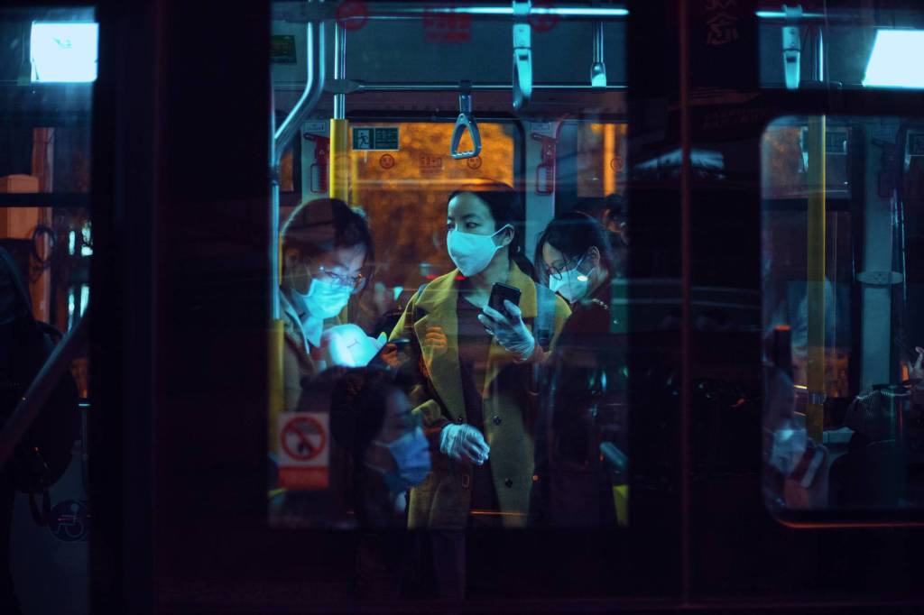 people inside a bus wearing masks